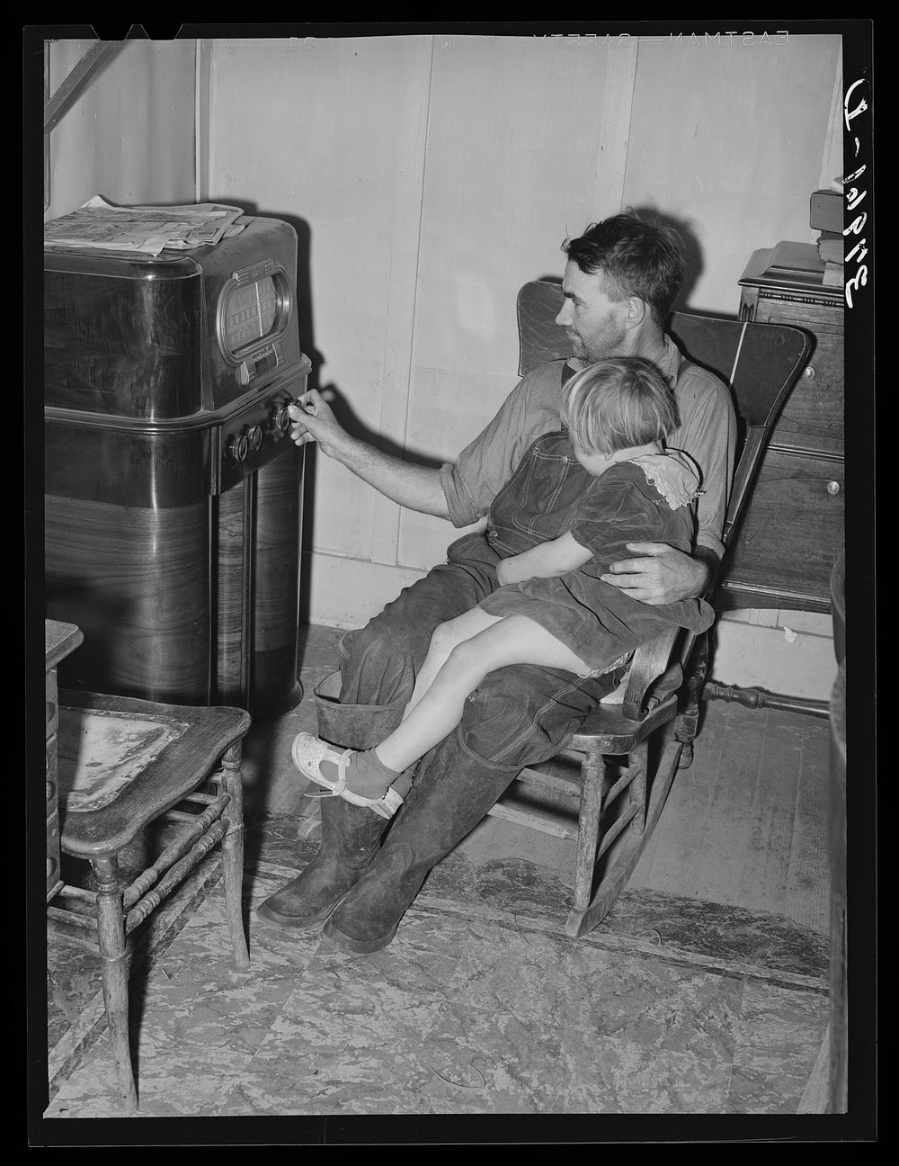 John Frost and daughter listening to radio in their home. Tehama County, California by Russell Lee
