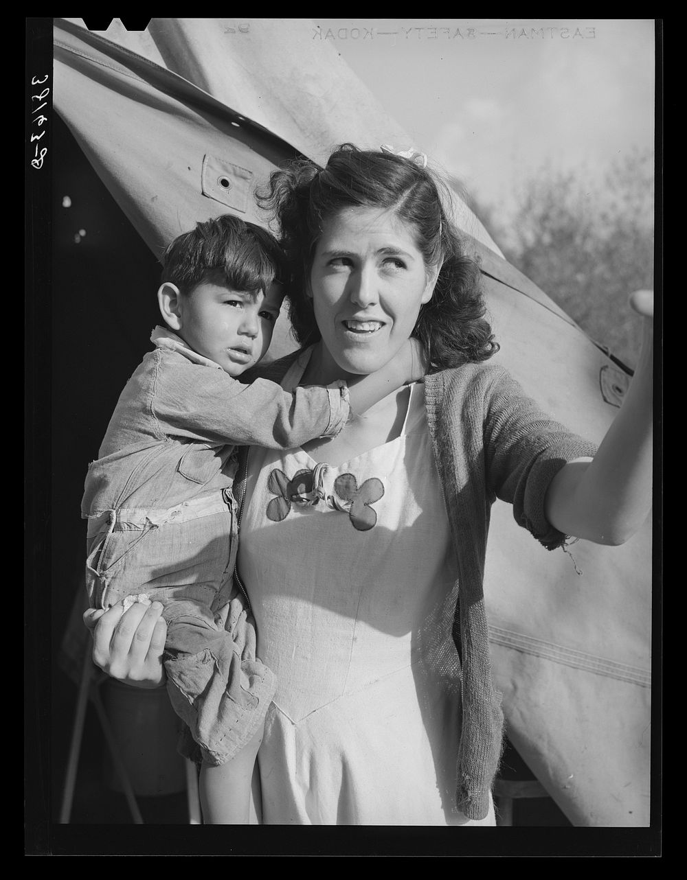 Mother and child in front of tent-home. This family is from Oregon. The man is a concrete worker. Mission Valley…