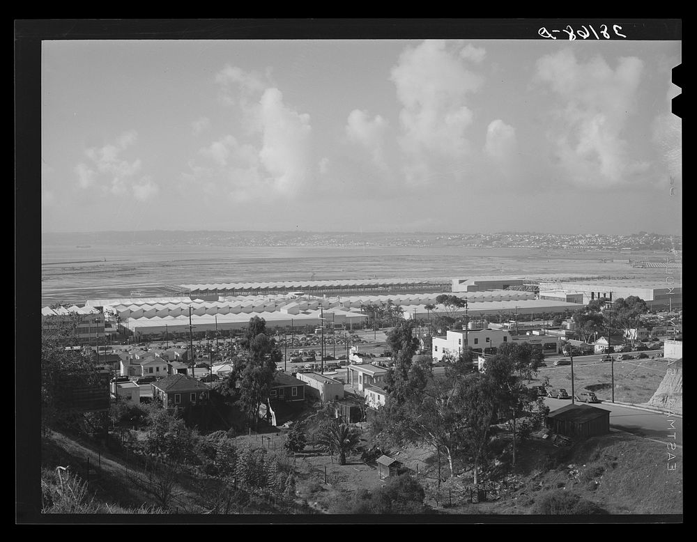 Workers' automobiles parked near the airplane factories. San Diego, California. Providing parking space for automobiles and…
