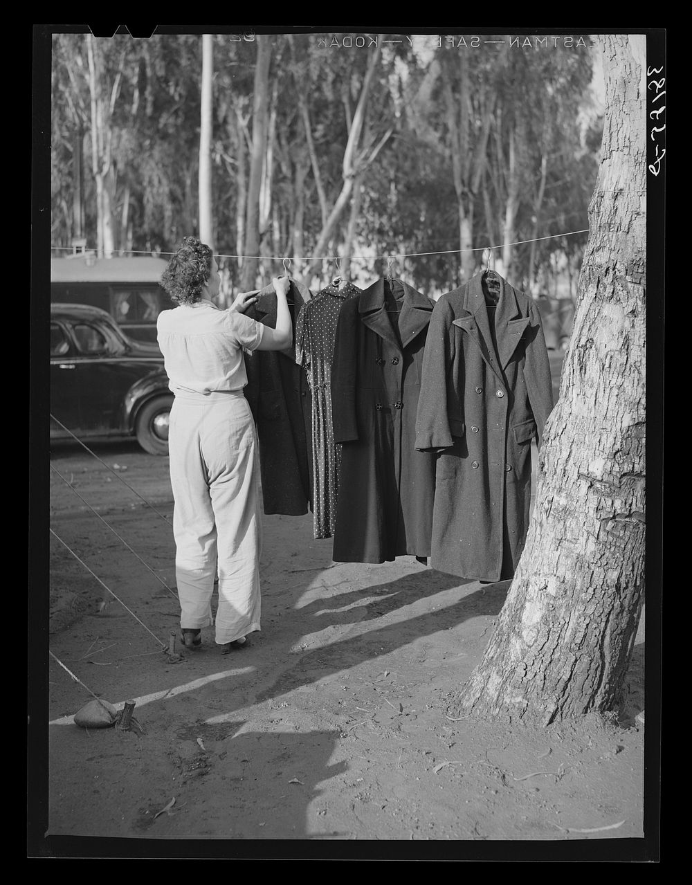 Carpenter's wife hanging up coat to dry. Mission Valley, California, which is about three miles from San Diego. This family…