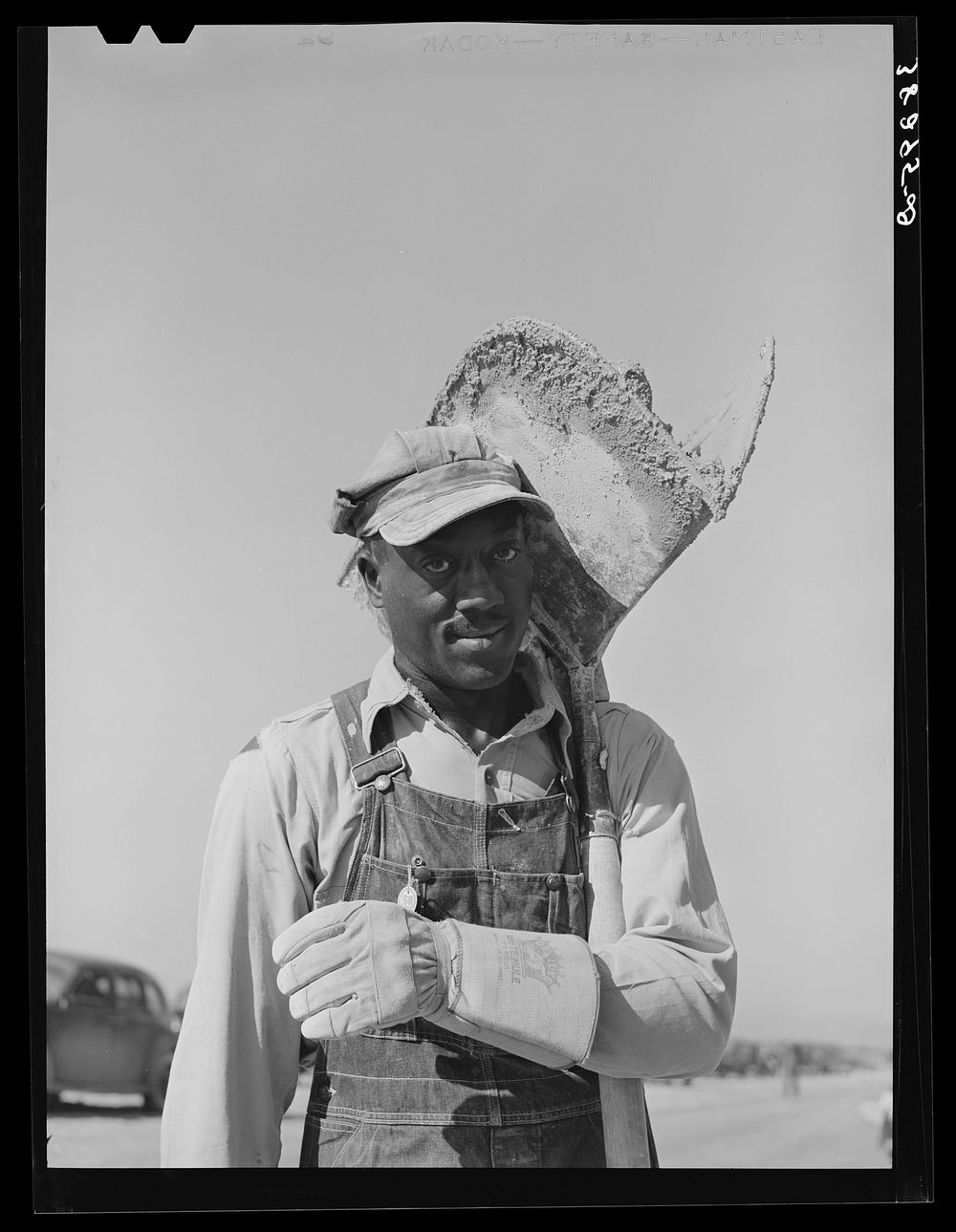 Hod carrier who is employed on U.S.H.A. project constructing two hundred forty-nine units for married enlisted men and…