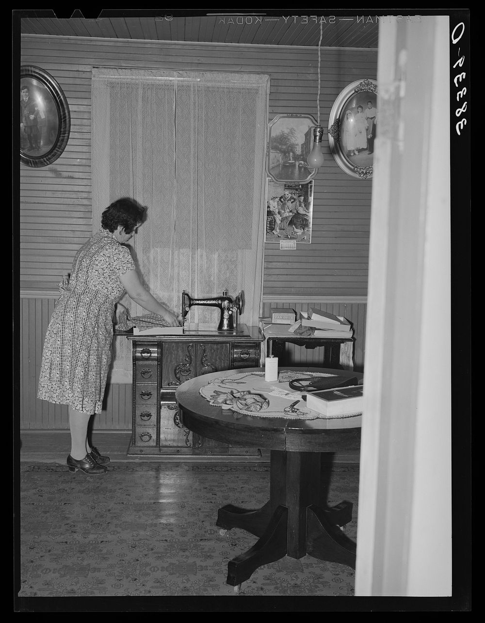 Farmer's wife at her sewing machine, near Auburn, Placer County, California by Russell Lee