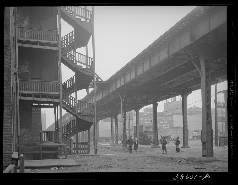 Children playing under the elevated on the southside of Chicago, Illinois by Russell Lee