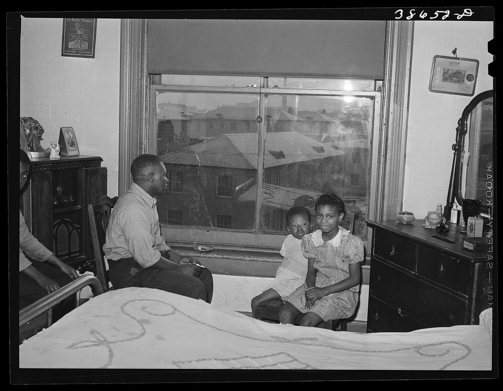 Front room of apartment rented by es. Ida B. Wells Housing Project can be seen through the window. Chicago, Illinois by…