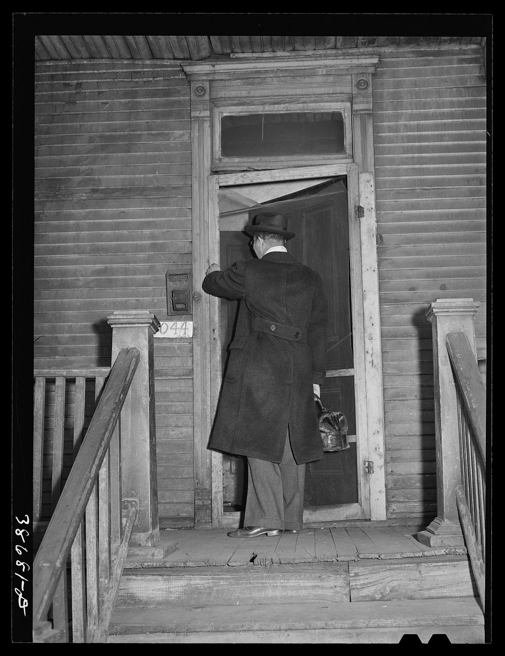 Doctor entering home of relief family. Chicago, Illinois by Russell Lee