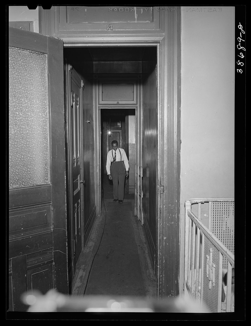 [Untitled photo, possibly related to: Hall leading to apartment of  railroad worker. Chicago, Illinois] by Russell Lee