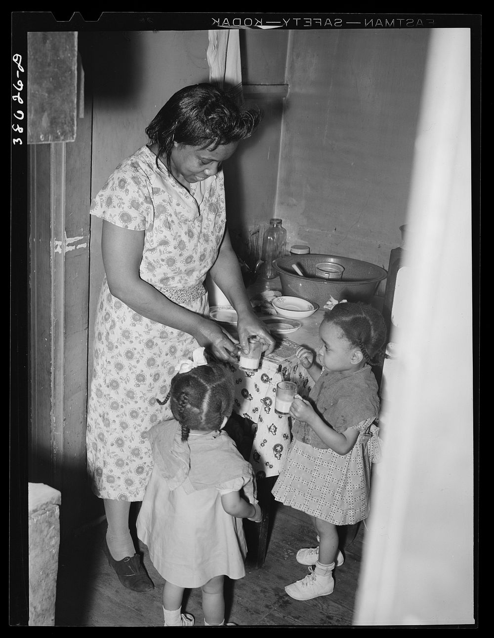Wife of railroad worker feeding her children. Chicago, Illinois by Russell Lee