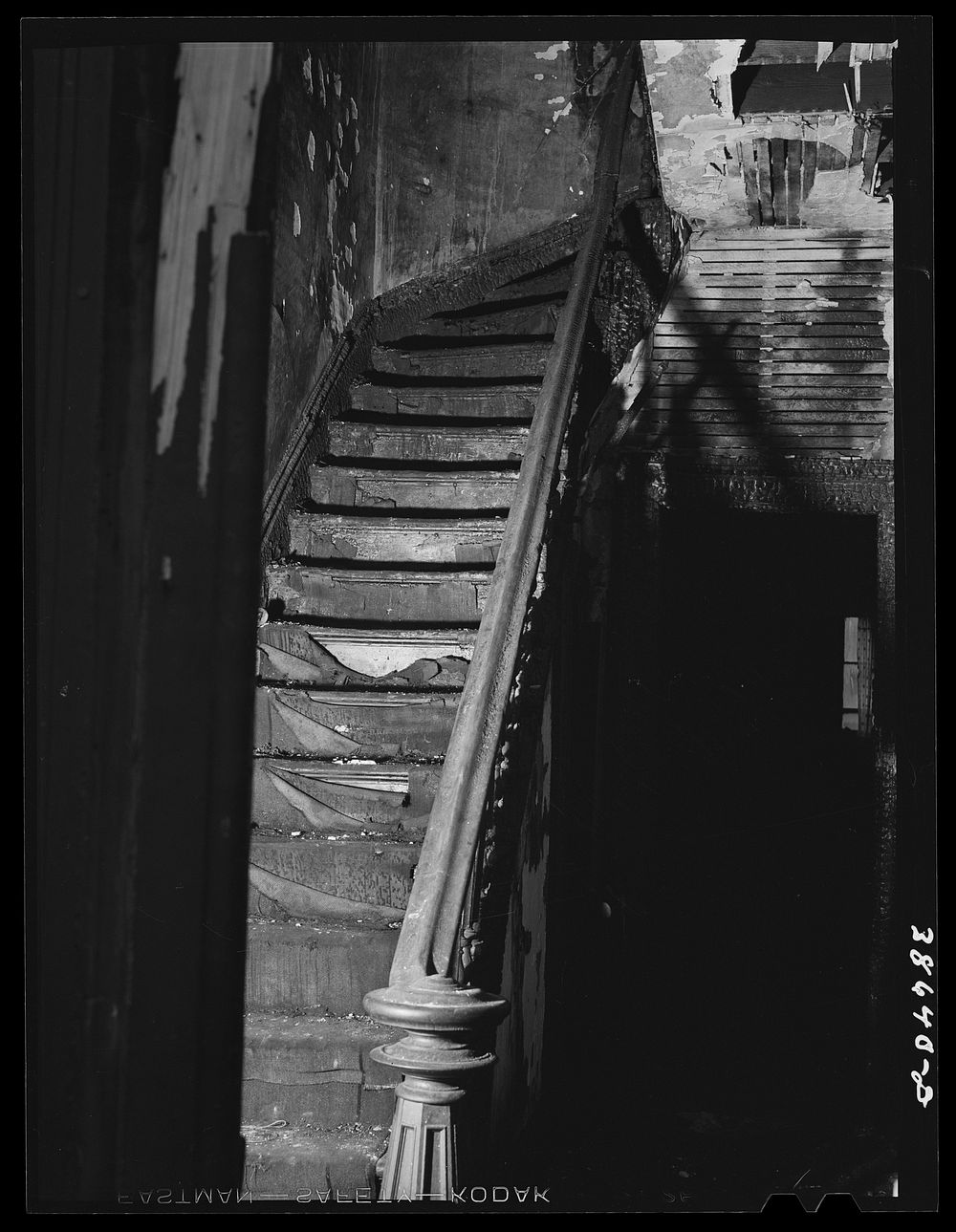 Staircase in hall of apartment buildings. This house is now vacant after fire. Chicago, Illinois by Russell Lee