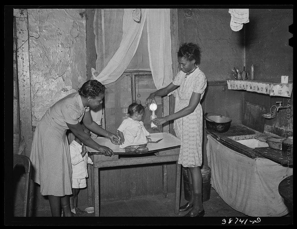 Preparing milk for baby. Family is on relief. Chicago, Illinois by Russell Lee