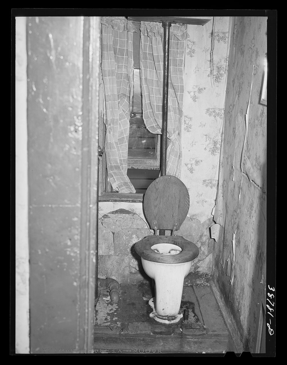 Toilet in home of family on relief. Chicago, Illinois by Russell Lee