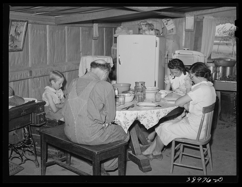The Browning family says grace before dinner. Mr. Browning is a  FSA  (Farm Security Administration) rehabilitation borrower…