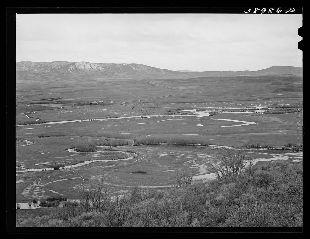 Yampo Valley, Routt County, Colorado, with snow-covered Rocky Mountains in the background. Notice the flooded fields caused…