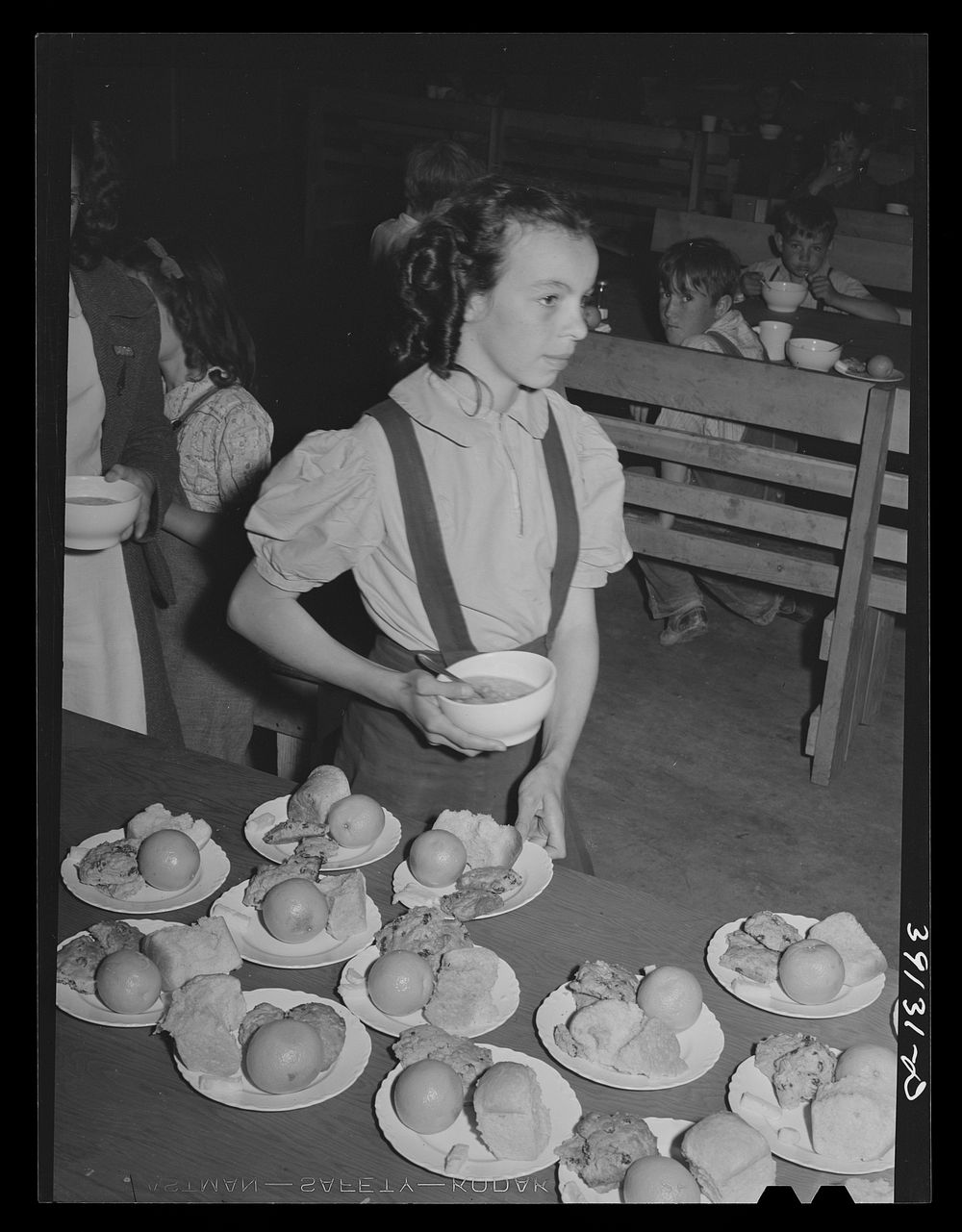 Lunch for schoolchildren, most of whose parents are working in the fields. FSA (Farm Security Administration) farm workers'…