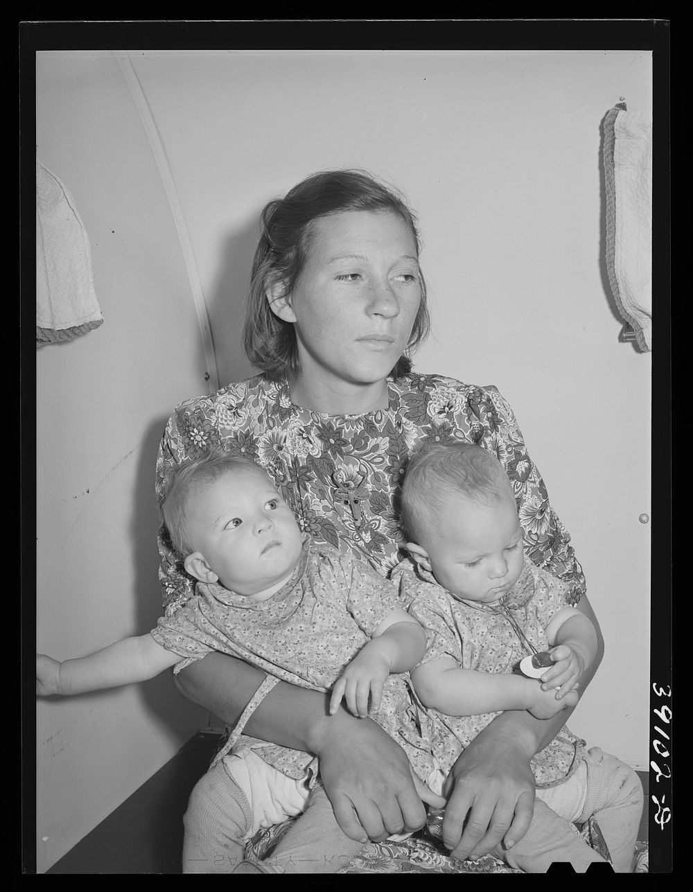 [Untitled photo, possibly related to: Mother and her twin babies in the trailer-clinic at the FSA (Farm Security…