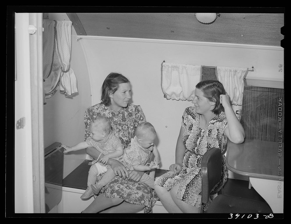 Wives and children of farm workers in the trailer-clinic at the FSA (Farm Security Administration) migratory labor camp…