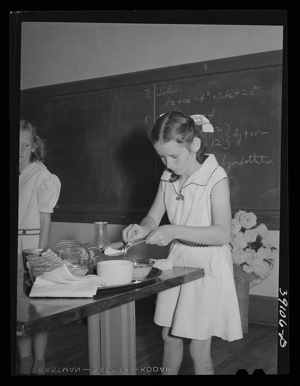 Schoolgirl demonstrating cooking methods at the 4-H Club Spring fair. Adrian, Oregon by Russell Lee