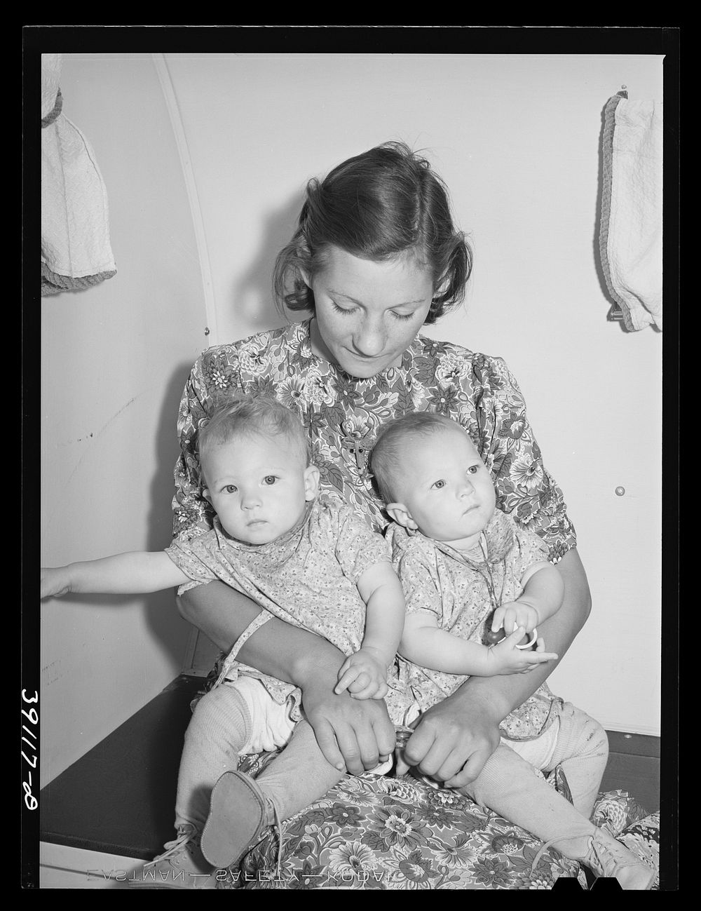 Mother and her twin babies in the trailer-clinic at the FSA (Farm Security Administration) migratory labor camp mobile unit.…