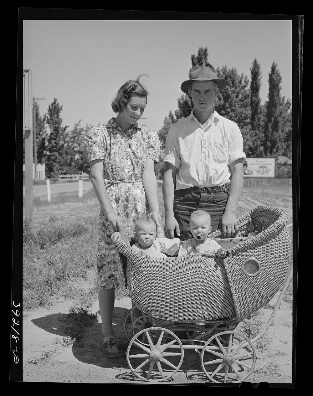 Farm worker with his wife and their twin babies at the FSA (Farm Security Administration) migratory labor camp mobile unit.…