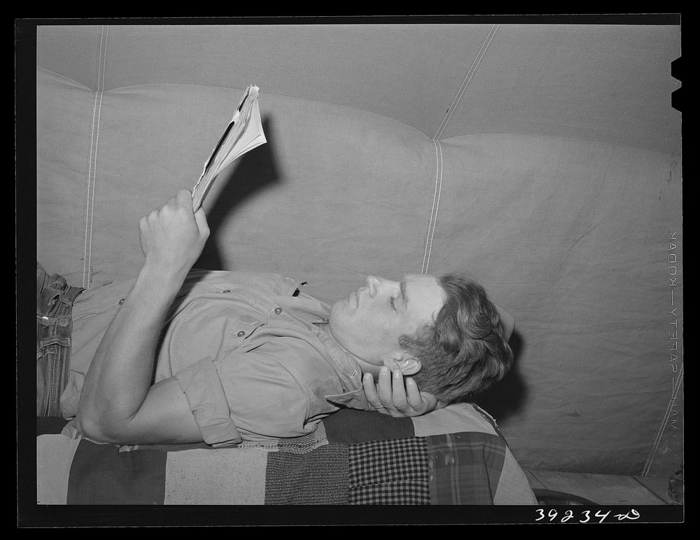 Young farm worker in tent at the FSA (Farm Security Administration) migratory labor camp mobile unit. Wilder, Idaho by…