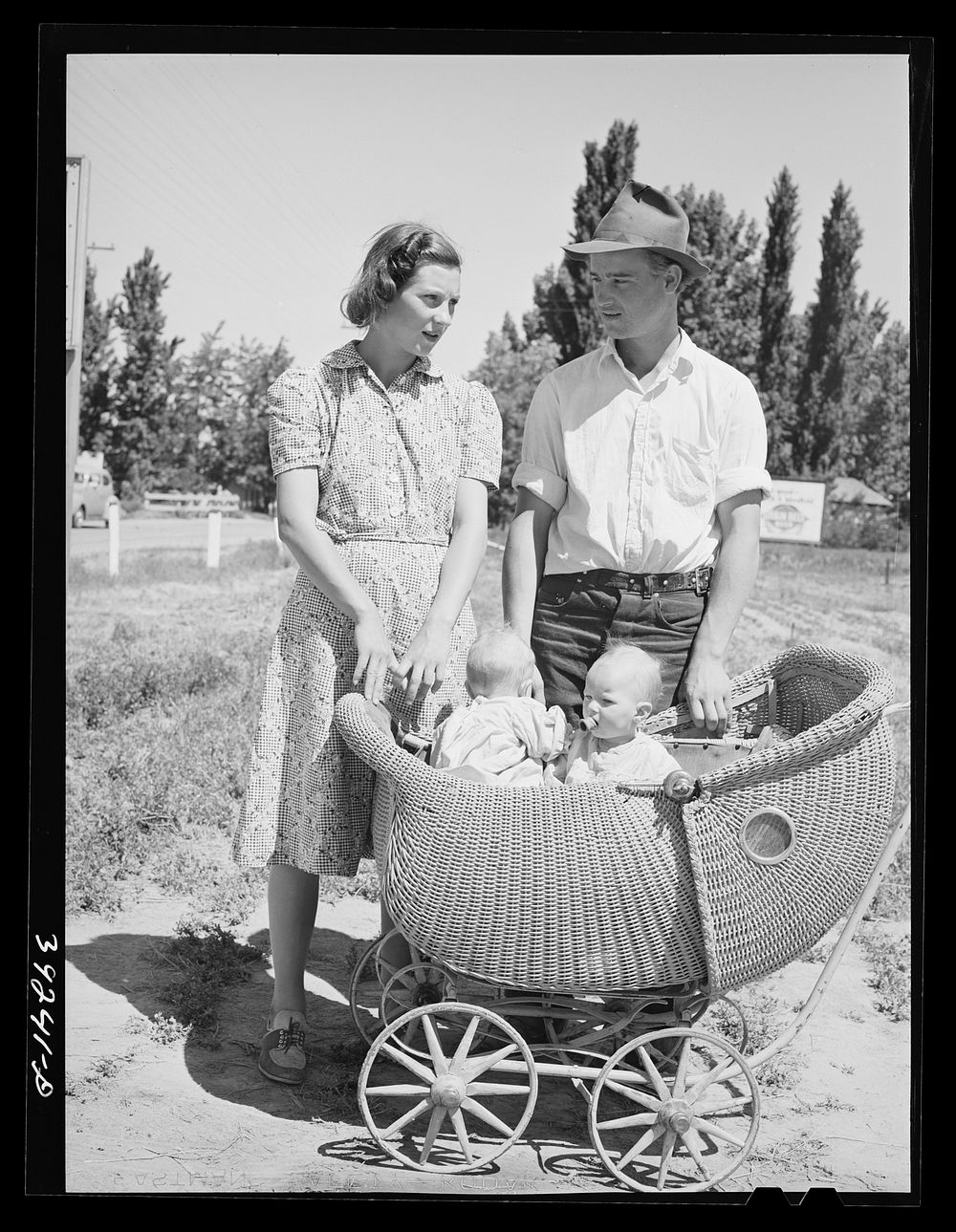 [Untitled photo, possibly related to: Farm worker with his wife and their twin babies at the FSA (Farm Security…