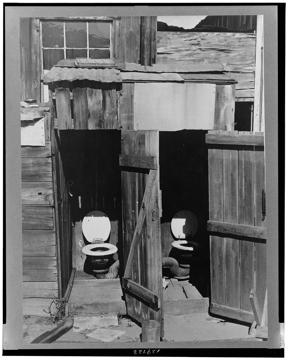 Toilets in court of houses in Mexican section. Cannery workers as well as some agricultural workers and unskilled laborers…