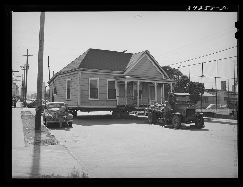 Old house being moved to make room for expansion of Arden Farms Creamery.  San Diego, California by Russell Lee