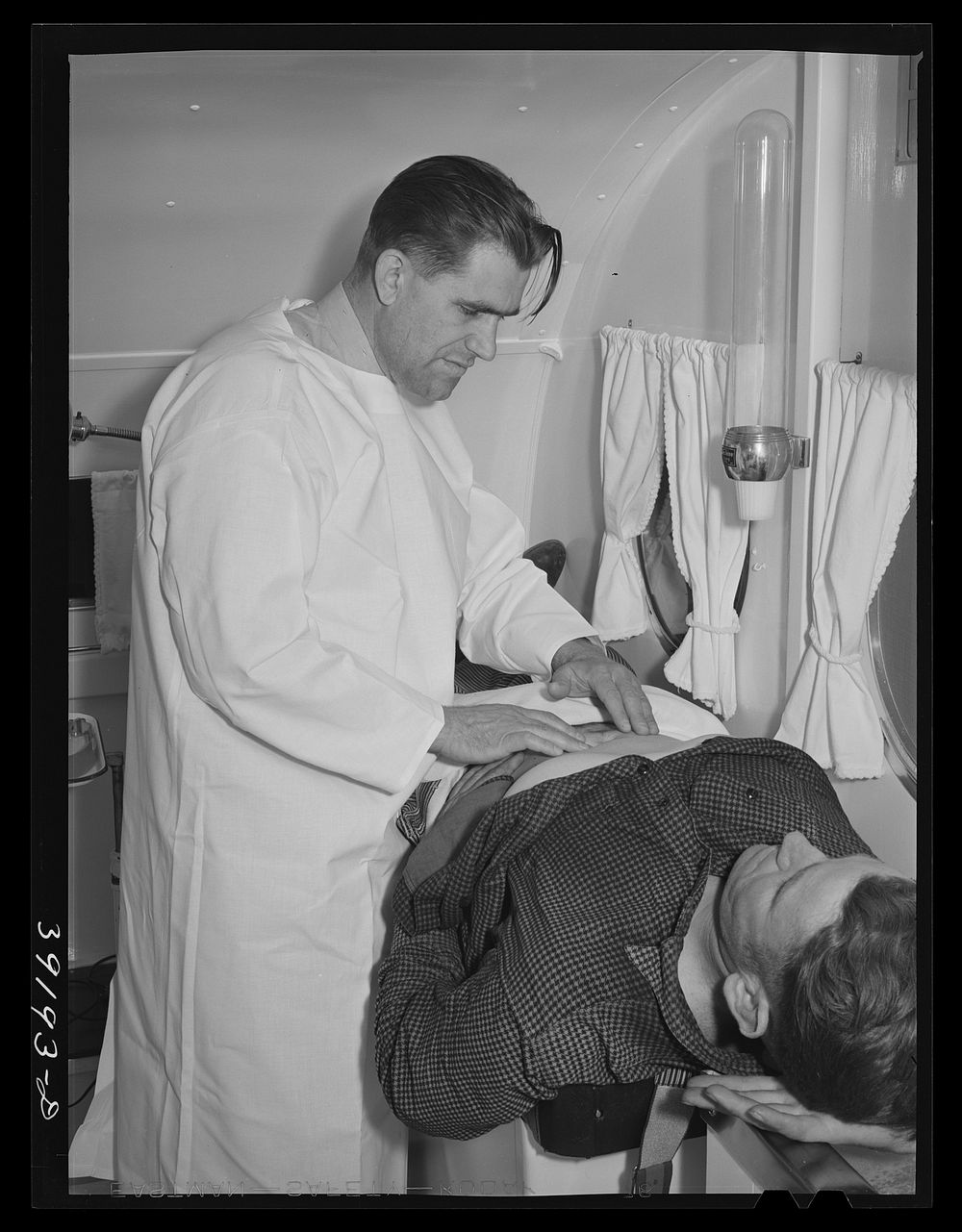 Examination in trailer-clinic at the FSA (Farm Security Administration) migratory labor camp mobile unit. Wilder, Idaho by…