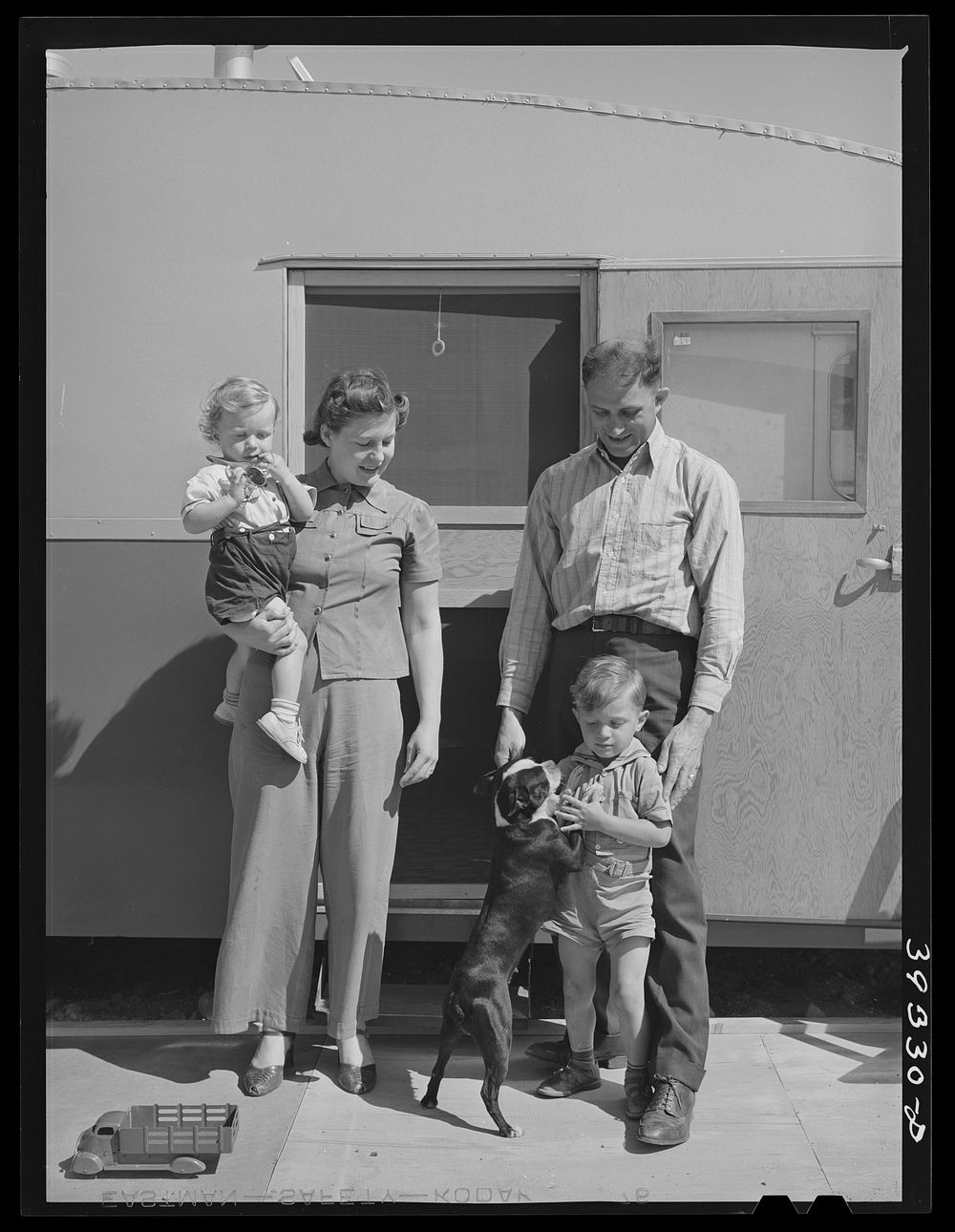 Family outside their trailer home at the FSA (Farm Security Administration) camp for defense workers. San Diego, California…