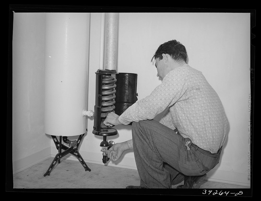 Lighting hot water heater in house at the Kearney Mesa defense housing project. This young man came out to California from…