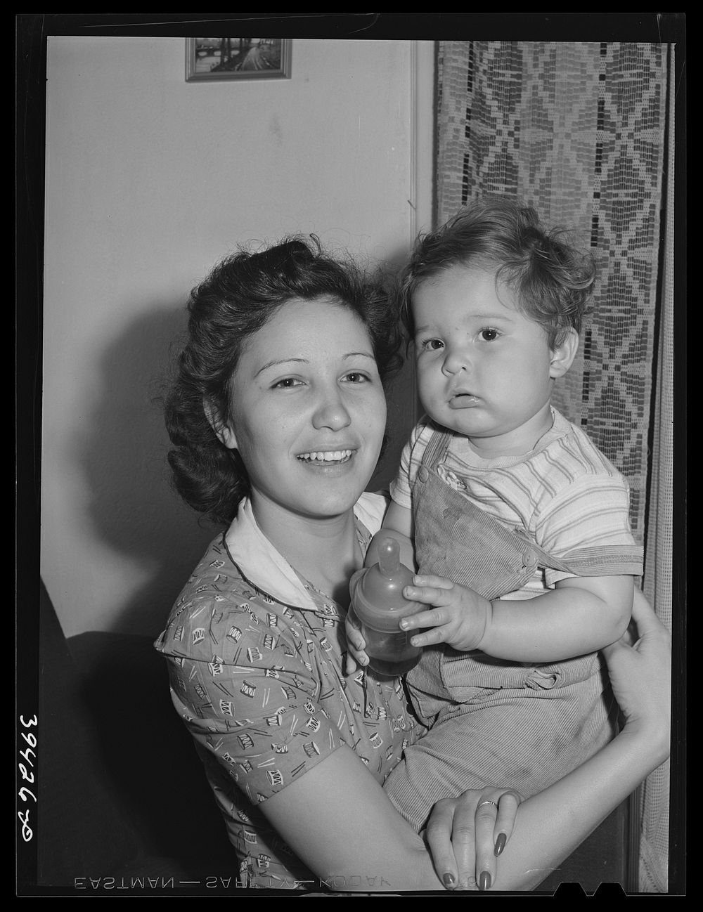 Mother and child who have moved to San Diego from San Angelo, Texas. The house this family lives in rented for twenty-two…