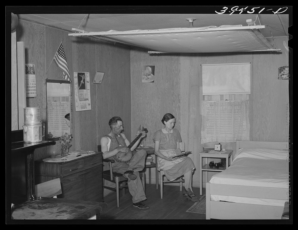 Farm worker and his wife in their cottage at the FSA (Farm Security Administration) labor camp. Caldwell, Idaho. Notice the…