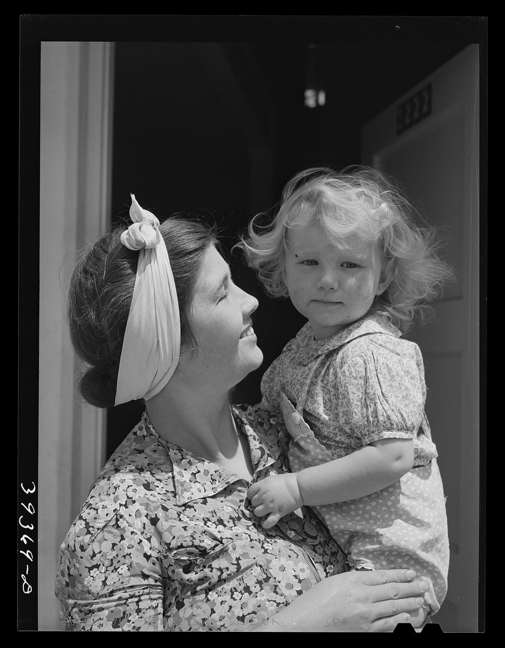 Mother and child who live in one of the family units of the Navy defense housing project for Marine and Navy enlisted men.…