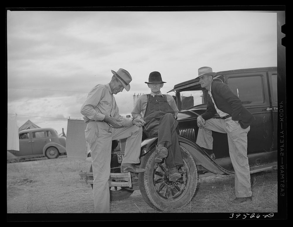 [Untitled photo, possibly related to: Pea pickers talking in camp. Canyon County, Idaho. These pickers travel with the labor…