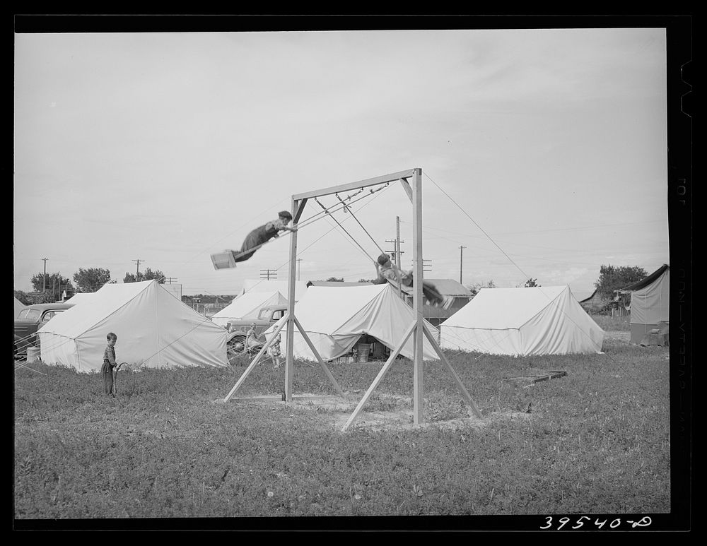 Children playing in mobile unit of FSA (Farm Security Administration) labor camp. Nampa, Idaho by Russell Lee