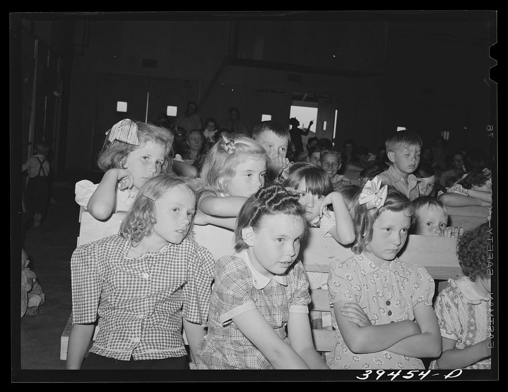 Schoolchildren watching the program given at the end of the school term.  FSA (Farm Security Administration) labor camp.…