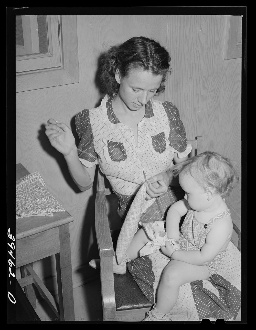 Mother and child. FSA (Farm Security Administration) farm labor camp. Caldwell, Idaho by Russell Lee