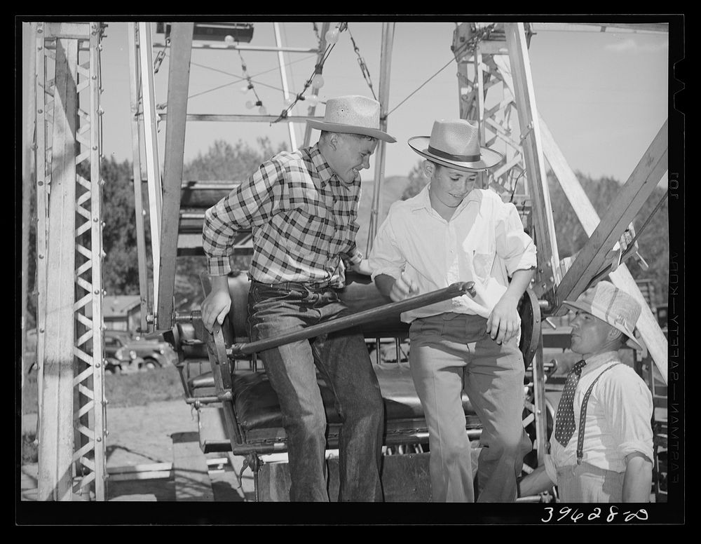 Farm boys getting on the ferris wheel, one of the attractions at the Fourth of July celebration at Vale, Oregon by Russell…