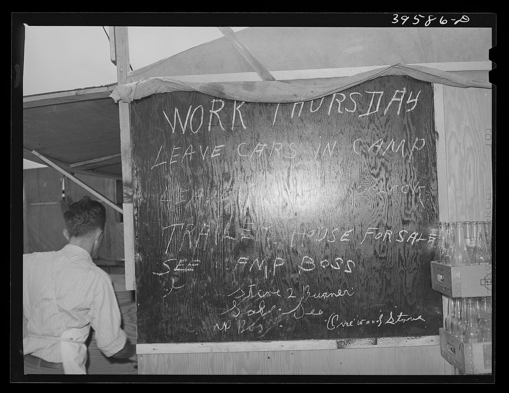 Bulletin board in labor contractor's camp (pea pickers). Canyon County, Idaho by Russell Lee