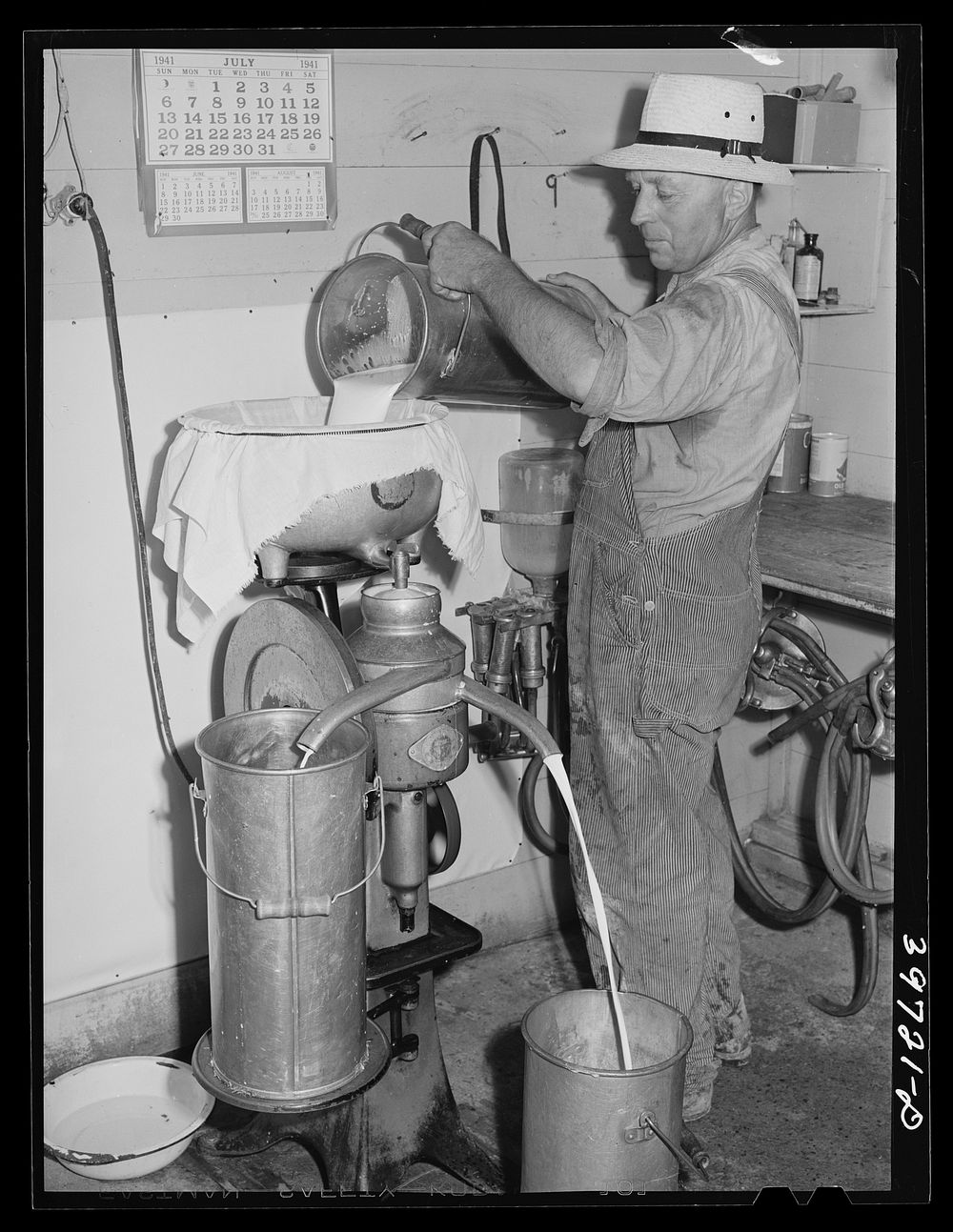 Member of the Dairymen's Cooperative Creamery uses cream separator on his farm. Caldwell, Canyon County, Idaho by Russell Lee