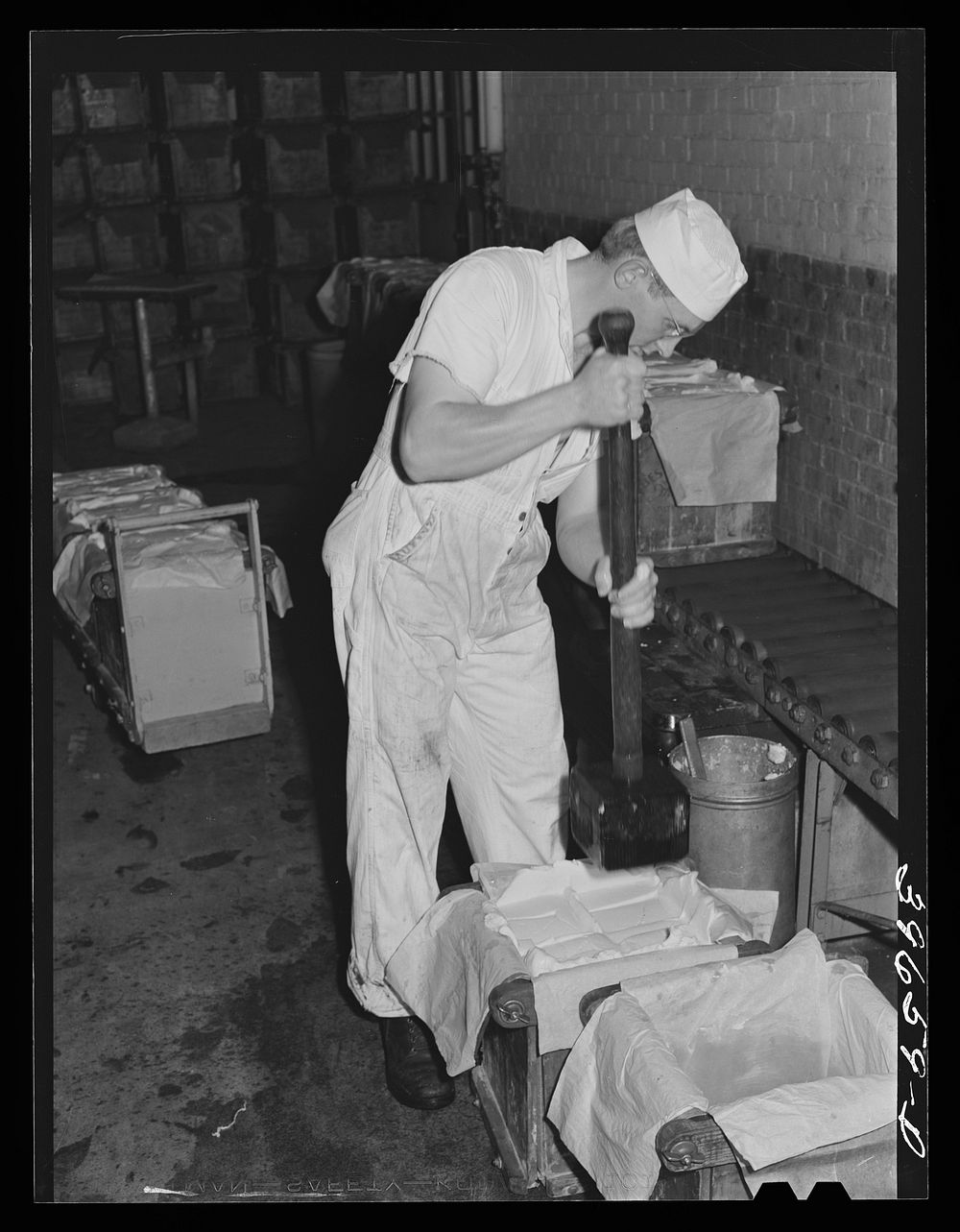 Packing butter into tubs at the Dairymen's Cooperative Creamery. Caldwell, Canyon County, Idaho. The dairymen's cooperative…