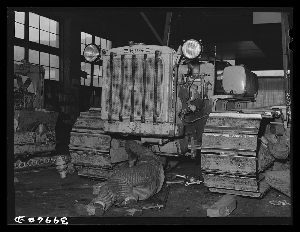 [Untitled photo, possibly related to: Caterpillar tractor in repair shop at Colfax, Washington. These tractors are used in…