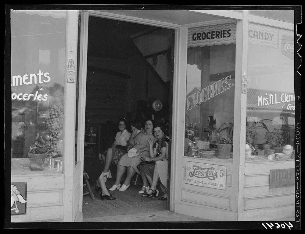 Farmers' wives gather at Mrs. Clement's grocery store to exchange gossip. Stem, Granville County, North Carolina. Sourced…