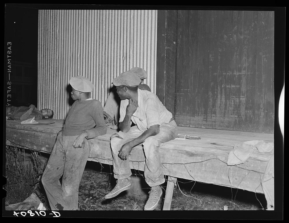 Migratory agricultural workers waiting to go on night shift at the grading station at Camden, North Carolina. Sourced from…
