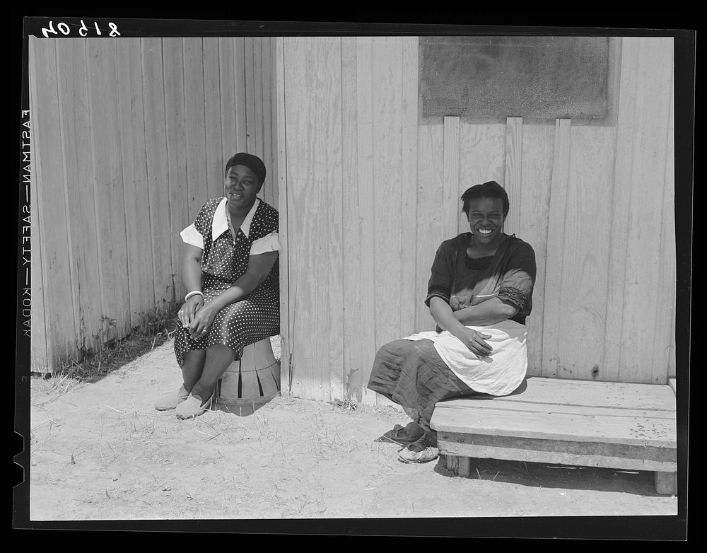 Two migratory workers at a camp in Vienna, Maryland, on a Sunday afternoon. Sourced from the Library of Congress.