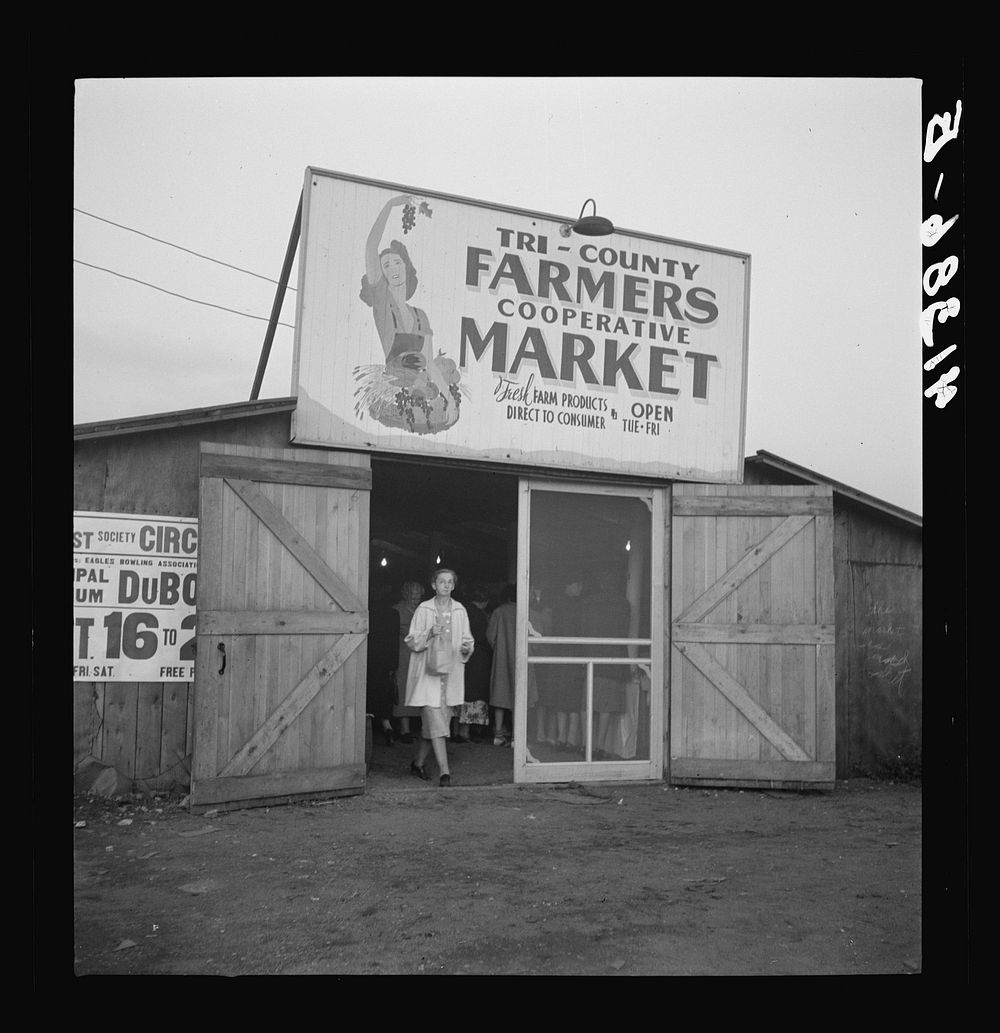 [Untitled photo, possibly related to: Customers at the entrance of the Tri-County Farmers Co-op Market in Du Bois…
