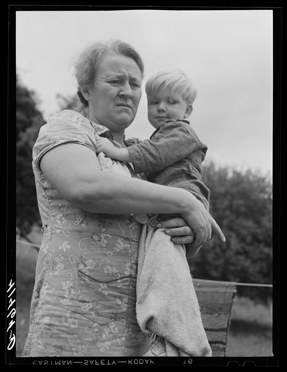 [Untitled photo, possibly related to: Farm woman holding one of her children in submarginal farm area of Rumsey Hill, near…