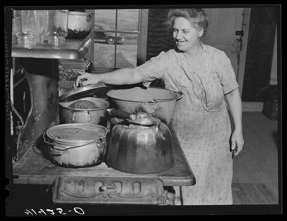 Mrs. Ben Harris preparing the evening meal. The Harrises come from Luzerne County, Pennsylvania. They have goats and sell…