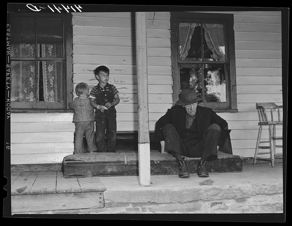 On the porch of Mr. Shoemaker's house. Blind old man and Mr. Shoemaker's children. They are farmers in the submarginal farm…