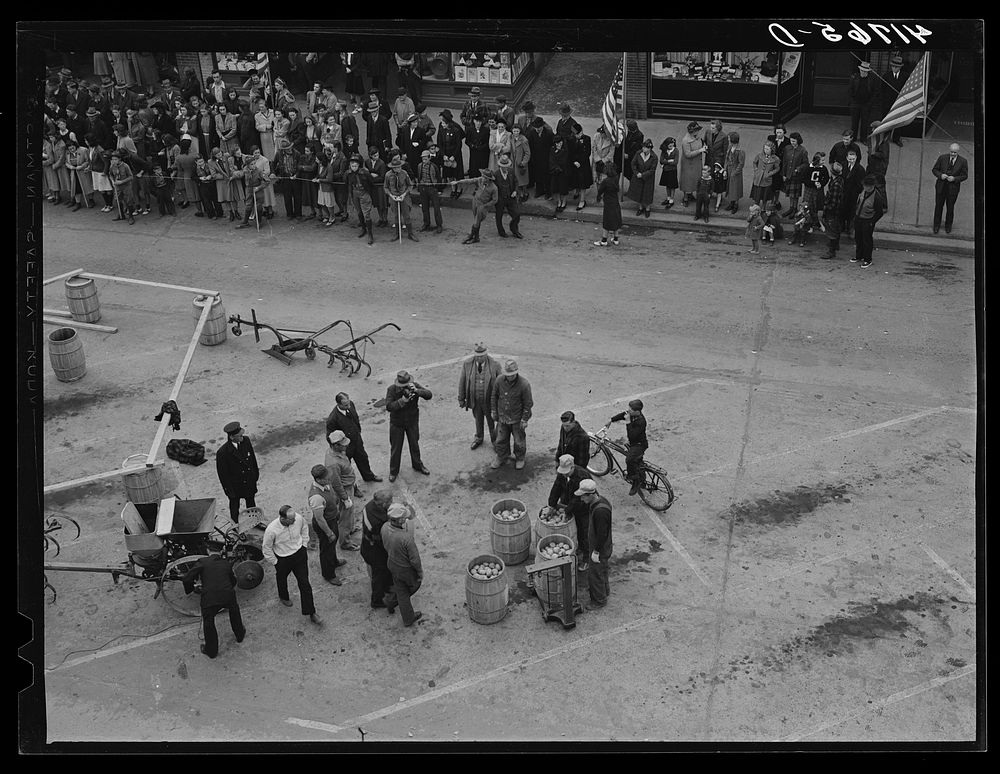 Weighing barrels of potatoes for the benefit of newsreel cameramen in Presque Isle Maine at the barrel rolling contest.…