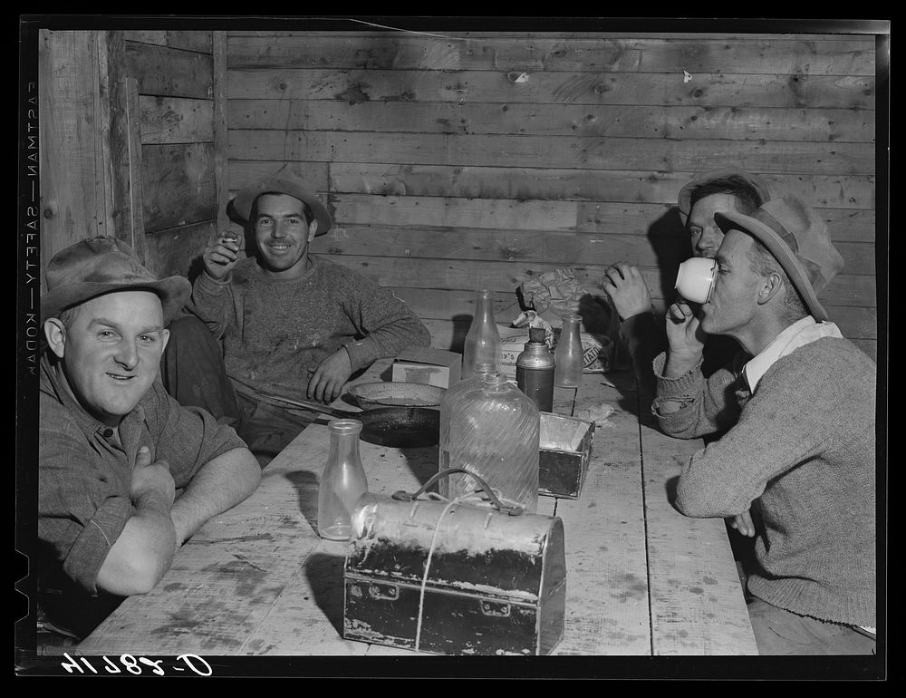 Workmen at the Woodman Potato Company just finishing lunch in a small room at the store house that serves as a lunchroom.…